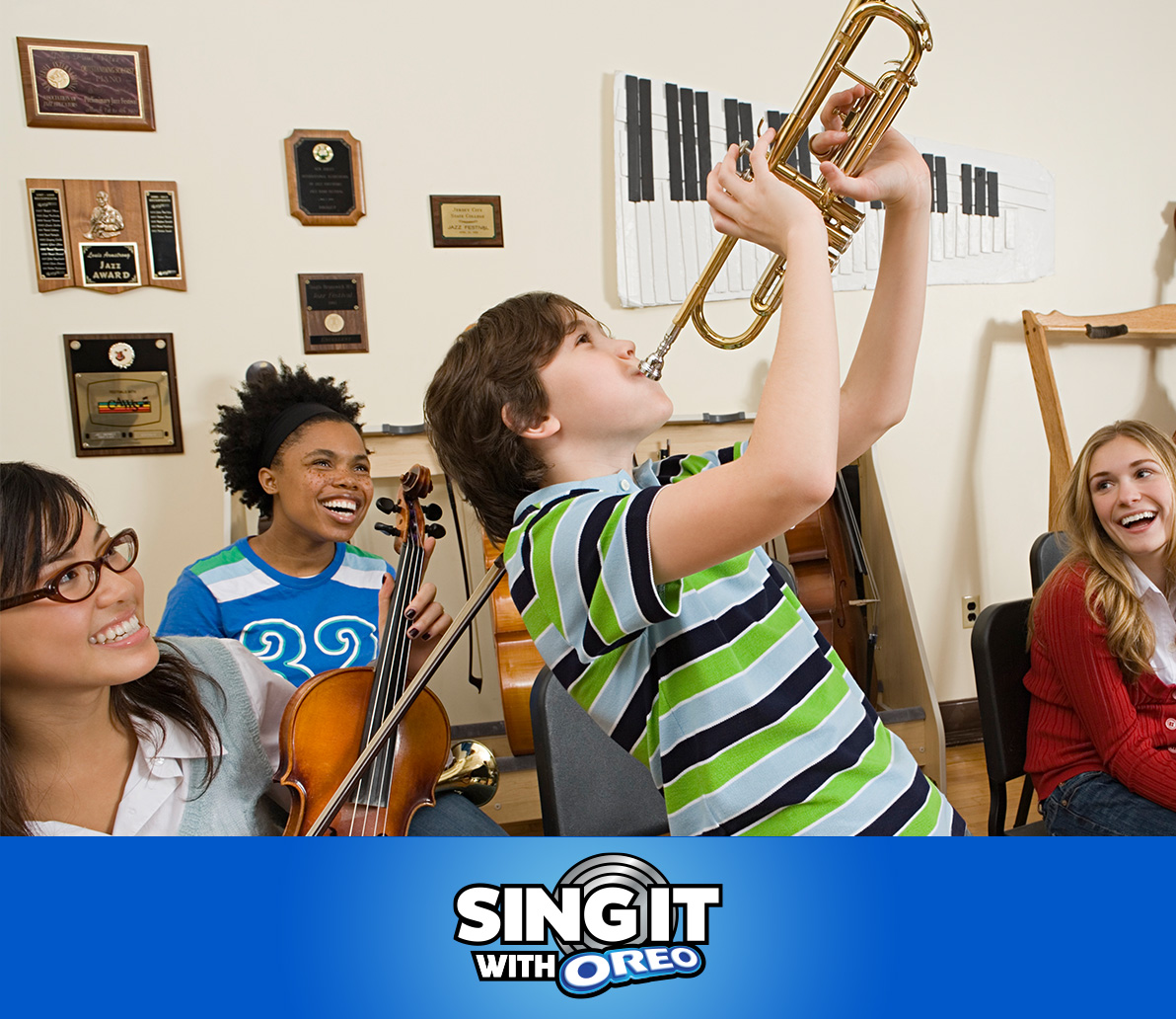 classroom of young children playing different musical instruments